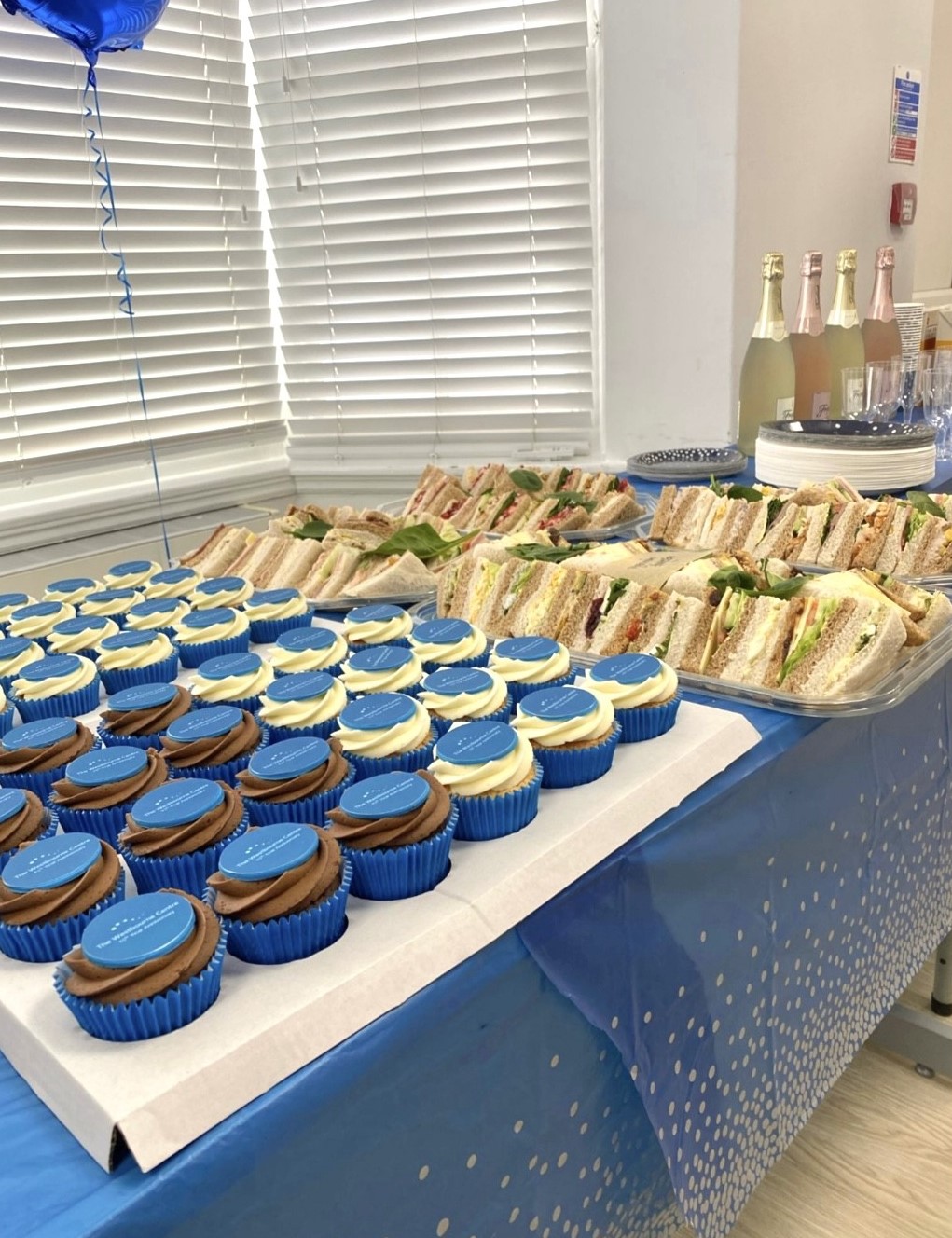 table with cupcakes and sandwiches