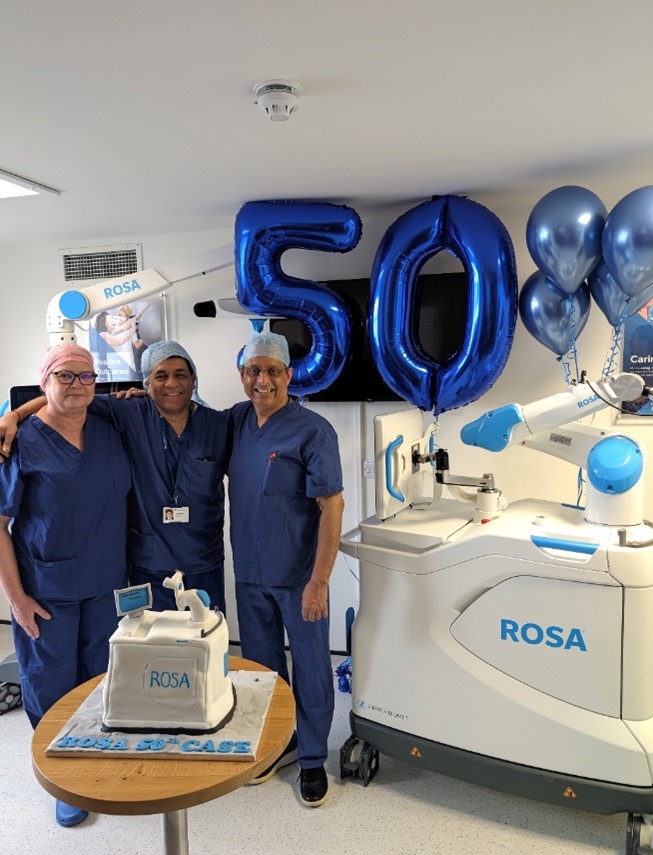 group of medical staff smiling with 50 balloons