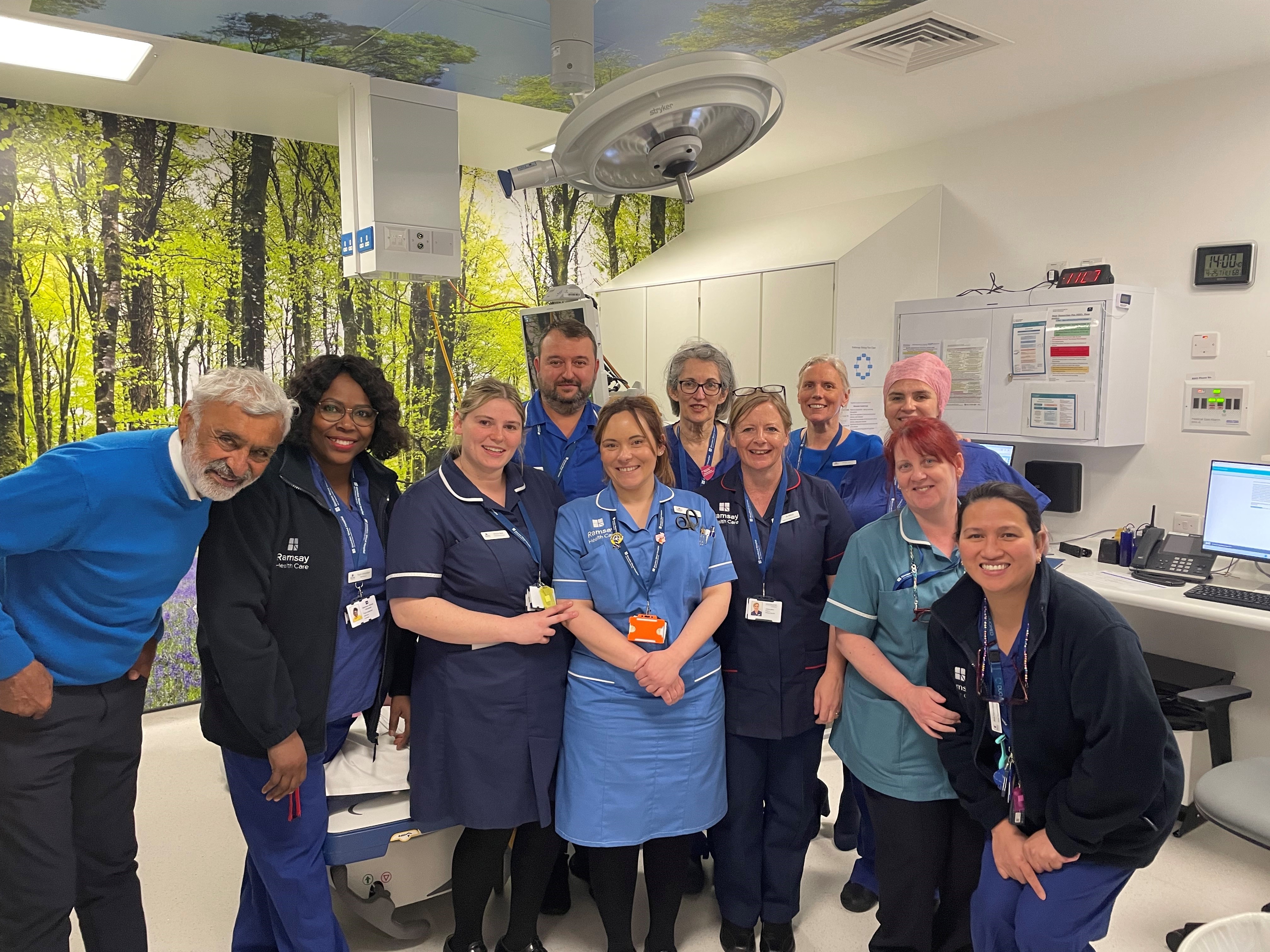 group of smiling clinical workers in hospital