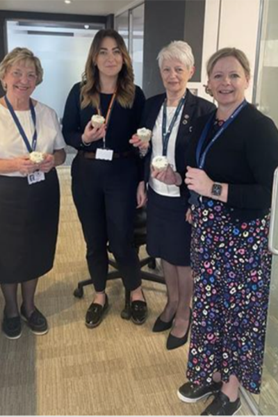 group of smiling hospital workers with cake