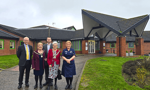people smiling outside hospital