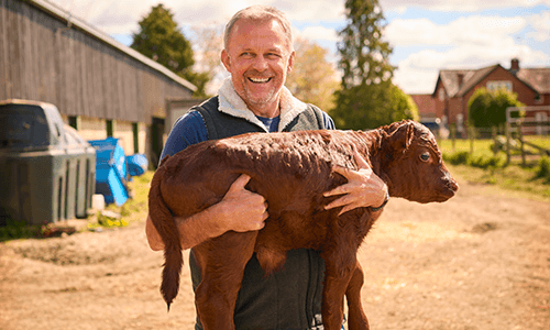 man holding calf