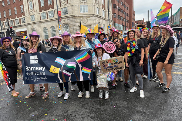 people smiling with pride flags