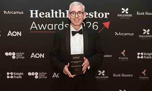 man smiling with award