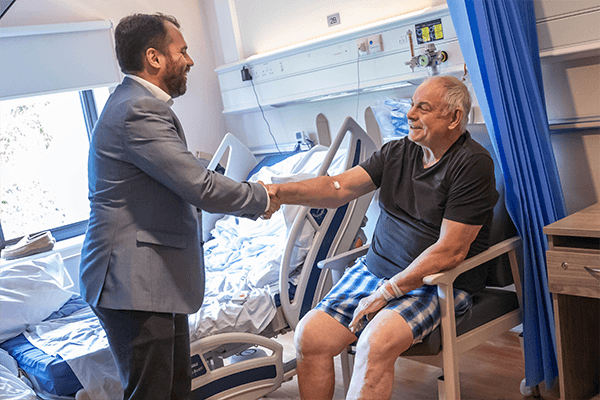 MP shaking patients hand