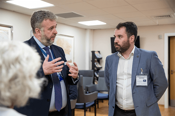 two professional men talking