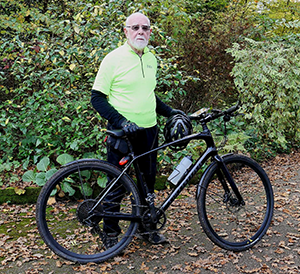 man smiling with bike
